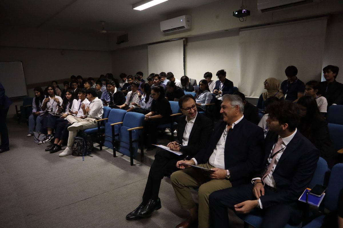 Judges seated in front of the audience during a pitch round